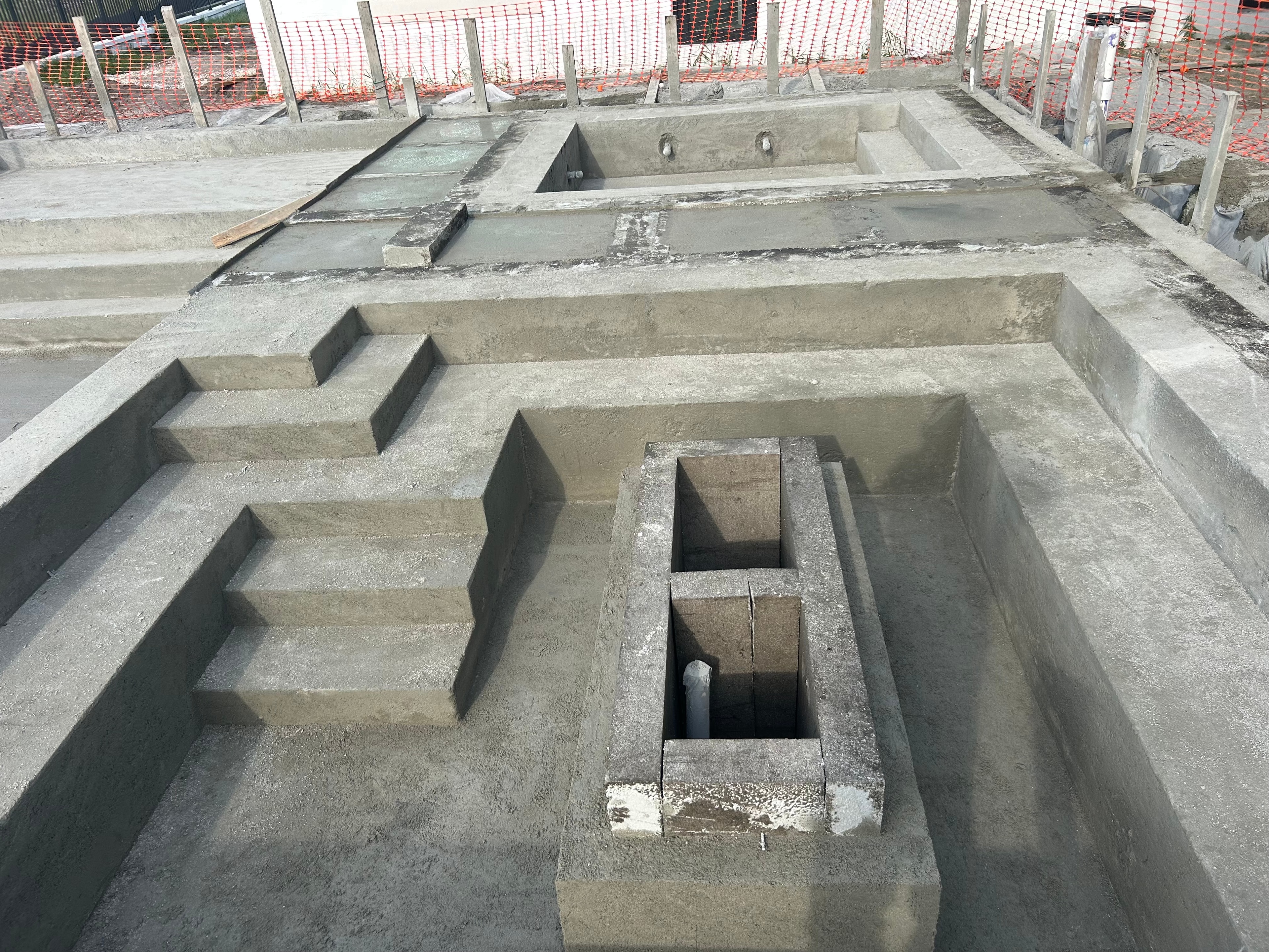 Overhead view of residential gunite pool shell with steps